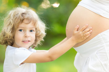 Poster - Child holding belly of pregnant woman