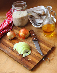 Frozen fish, rice groats and onions. Ingredients for lean dinner