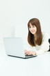 © one - Beautiful young woman using a laptop computer