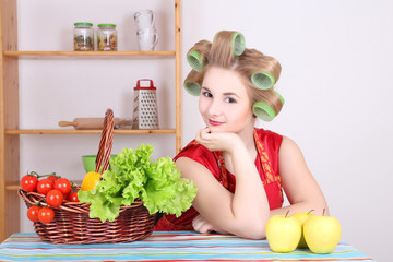 Wall Mural - beautiful housewife with hair curlers in the kitchen