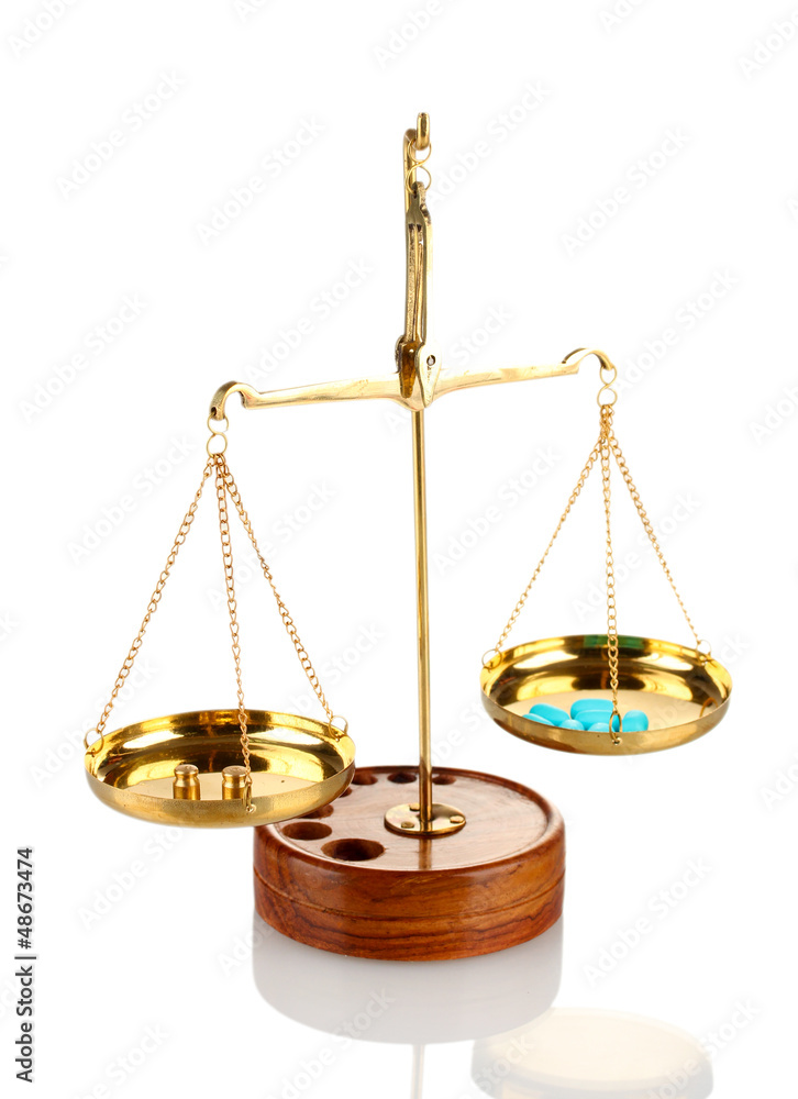 Classic scales with color pills isolated on white