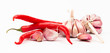 Red chilli peppers and garlic cloves on white background