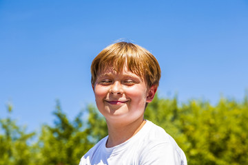 Wall Mural - happy boy is smiling and closes eyes