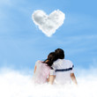 Asian couple looking at love clouds