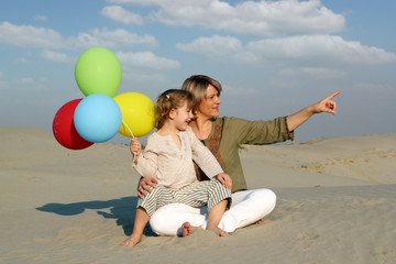 Wall Mural - happy mother and daughter with colorful balloons