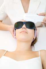 Wall Mural - Young woman receiving laser therapy