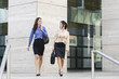 © Kevin Dodge/Blend Images - Hispanic businesswomen walking together