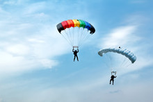 Unidentified Skydivers On Blue Sky