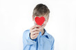 © katrin_timoff - Boy hiding himself behind a red heart.