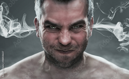 Fotografía Close up of angry man with steam coming out from his ears