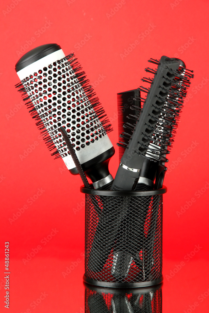 Iron basket with combs and round hair brushes,
