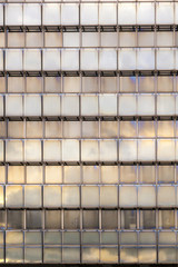 Wall Mural - reflection of sky and clouds in a facade of a skyscraper