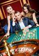 © Karramba Production - Man accompanied by woman placing bets at the casino