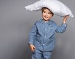 © Nejron Photo - Little boy in blue pyjamas with pillow