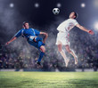 © Sergey Nivens - two football players striking the ball