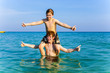 © travelview - brothers are enjoying the clear warm water in the ocean and play