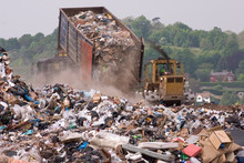 A Bulldozer And Garbage Truck On A Landfill Waste Site