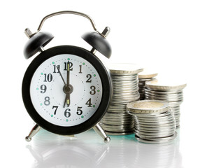 Alarm clock with coins isolated on white