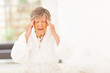 © michaeljung - senior woman feeling headache at home