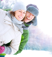 Wall Mural - Happy Couple Having Fun Outdoors. Snow. Winter Vacation