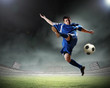 © Sergey Nivens - football player striking the ball