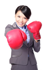 Canvas Print - business woman punching by boxing gloves