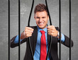 © Viorel Sima - businessman bending the bars of his prison