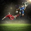 © Sergey Nivens - two football players striking the ball