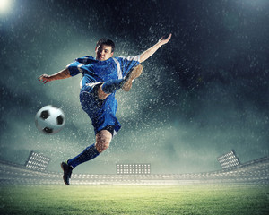 Wall Mural - football player striking the ball