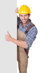 Wall Mural - Construction worker presenting empty banner