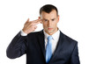 © Karramba Production - Disappointed businessman shows hand gun gesture