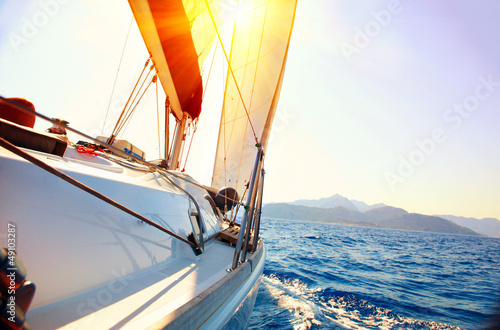 Fototapeta do kuchni Yacht Sailing against sunset. Sailboat. Yachting. Sailing