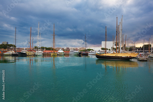 Fotoboard na płycie Port vell - marina w barcelonie. 