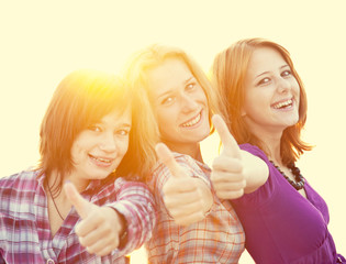 Sticker - Portrait of three beautiful girls. With counter light on backgro