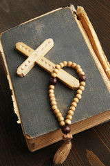 Wall Mural - Bible, rosary and cross on wooden table close-up