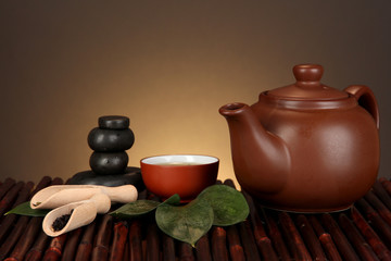 Wall Mural - Chinese tea ceremony on bamboo table on brown background