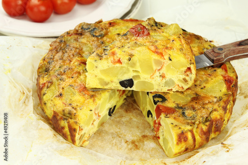 Fotografie, Obraz Spanish potato tortilla with black olives and tomatoes