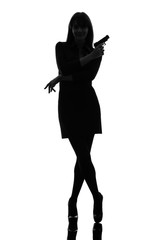 Wall Mural - sexy detective  woman holding aiming  gun silhouette