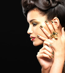 Beautiful woman with golden nails and style makeup