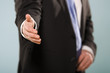 © blindfire - Friendly businessman offering to shake hands.