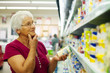 Senior woman at groceries store.