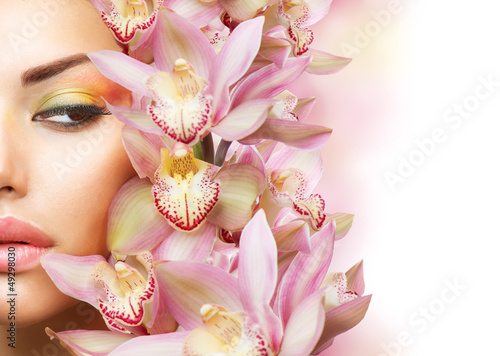 Fototapeta do kuchni Beautiful Girl With Orchid Flowers. Beauty Model Woman Face