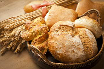 Wall Mural - assortment of fresh baked bread on wood table