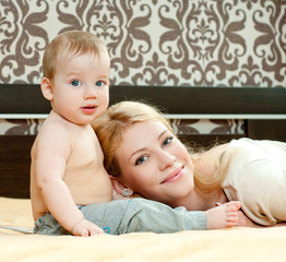 young mother with a charming baby. indoors.