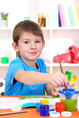 Wall Mural - Cute little boy painting in his album