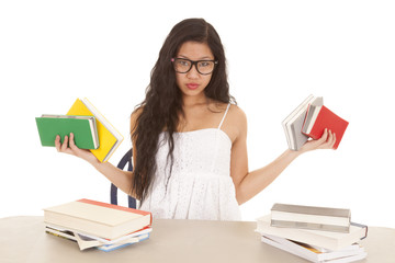 Asian woman holding up books