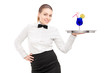 © Ljupco Smokovski - A waitress with bow tie holding a tray with cocktail on it tray