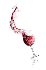 red wine splashing out of a glass, isolated on white