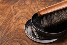 Container Of Shoe Polish And Brush On Wooden