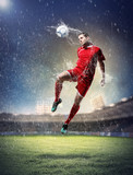 Fototapeta Sport - football player striking the ball